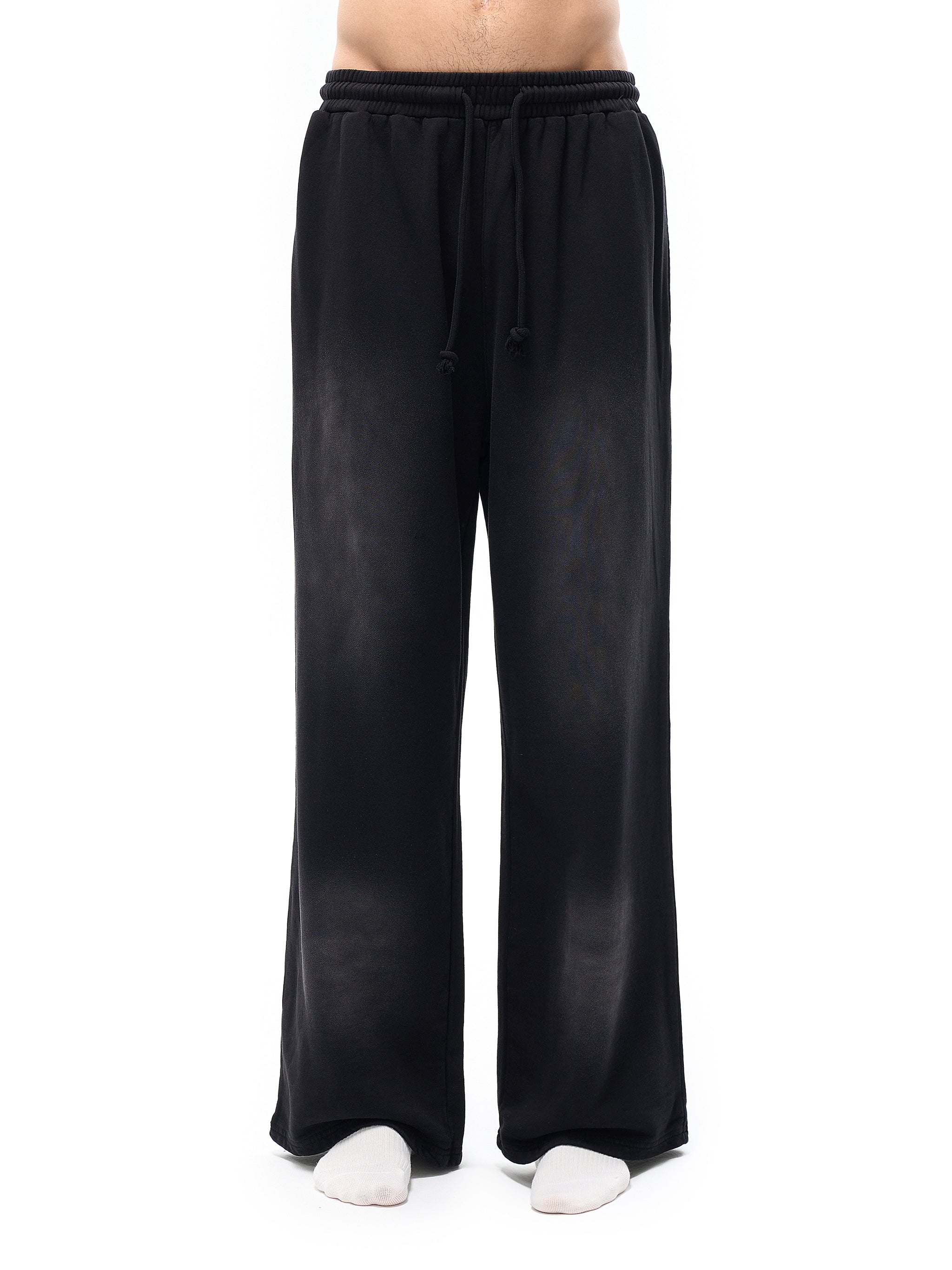Black wide-leg pants worn by a person on a white background