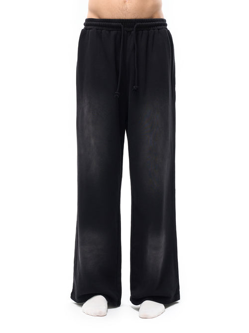 Black wide-leg pants worn by a person on a white background