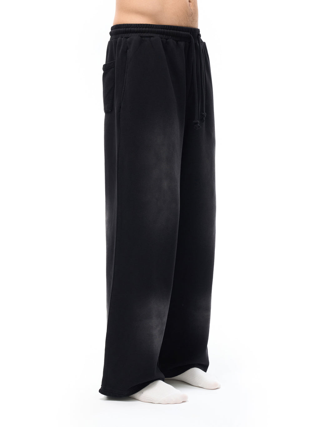 Black wide-leg pants worn by a person on a white background