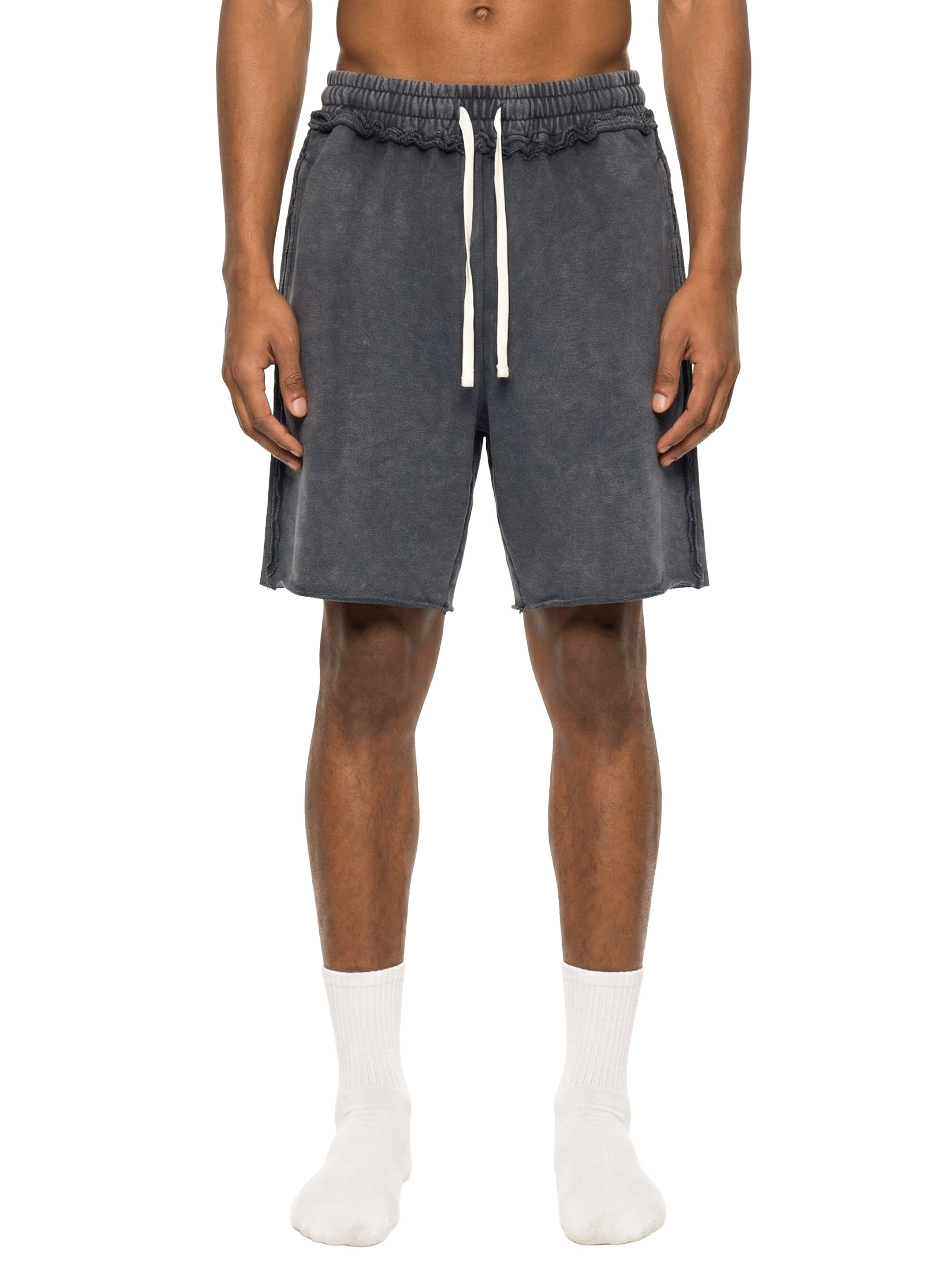 Person wearing gray shorts with a drawstring on a white background