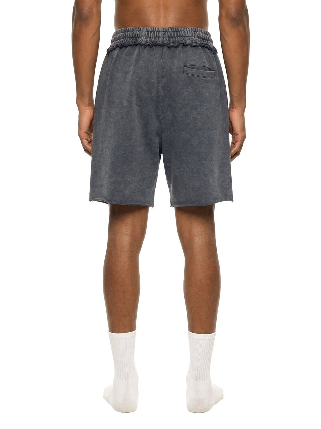 Person wearing dark gray shorts on a white background