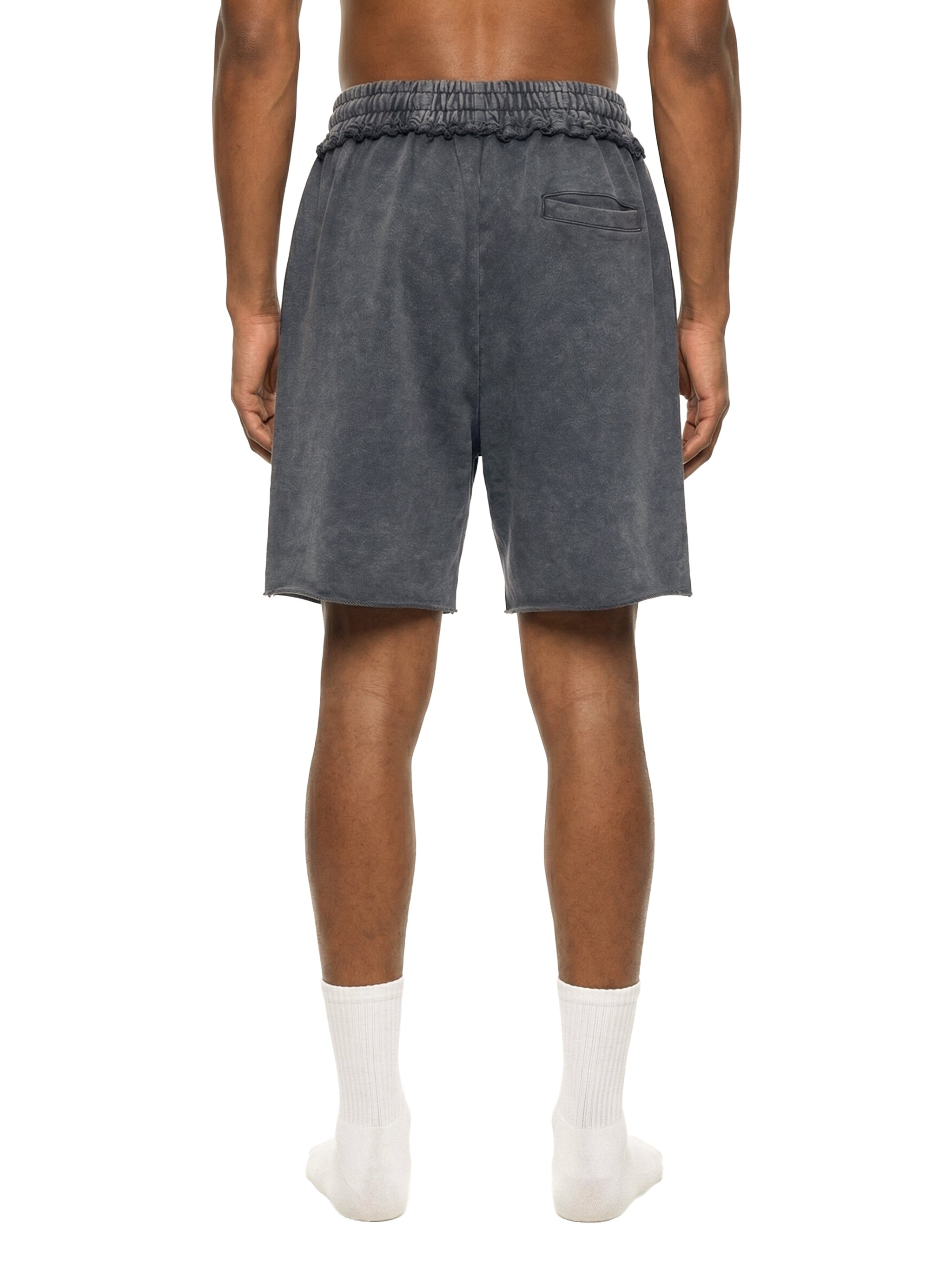 Person wearing dark gray shorts on a white background