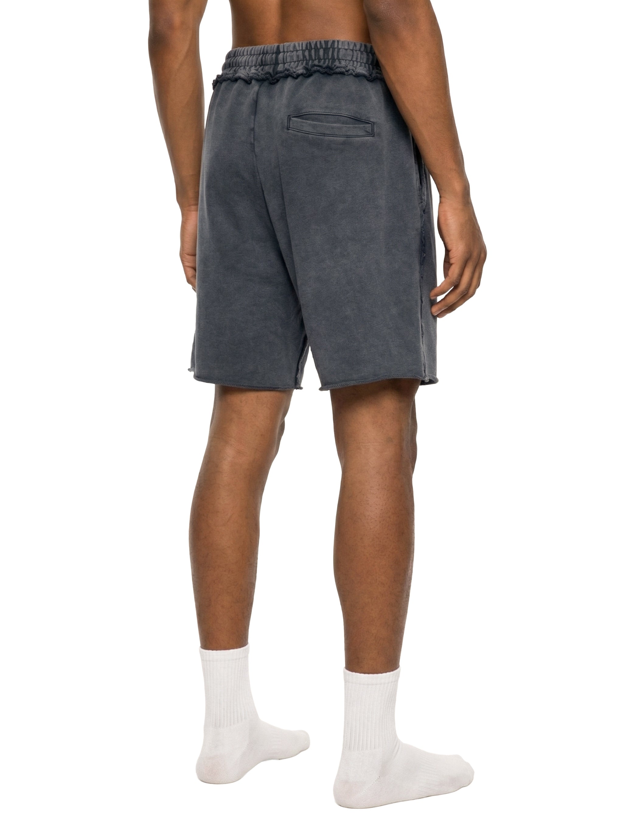 Person wearing gray shorts on a white background